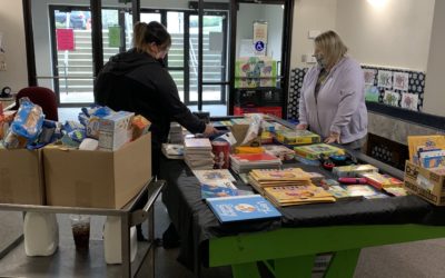 CIS staff organize books and supplies donated for kids during the COVID-19 pandemic.