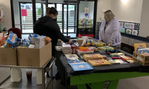 CIS staff organize books and supplies donated for kids during the COVID-19 pandemic.